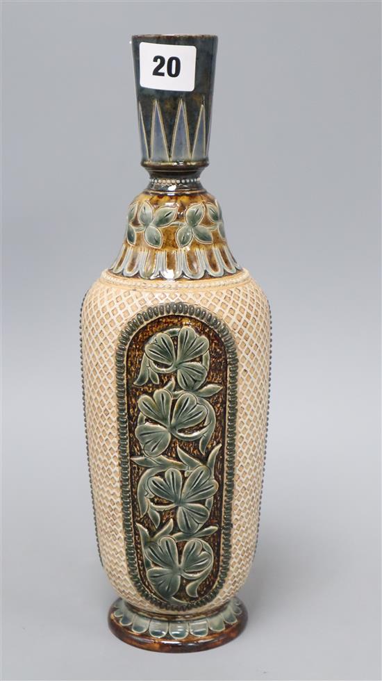 A Doulton Lambeth slender bottle vase, by Florence E Lewis, dated 1879, with foliate panels on a lattice ground, H. 32.5cm